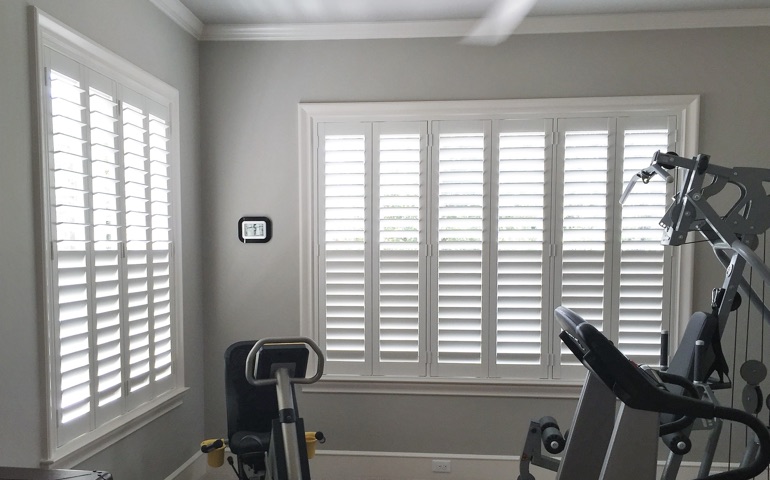 Sacramento home gym with shuttered windows.